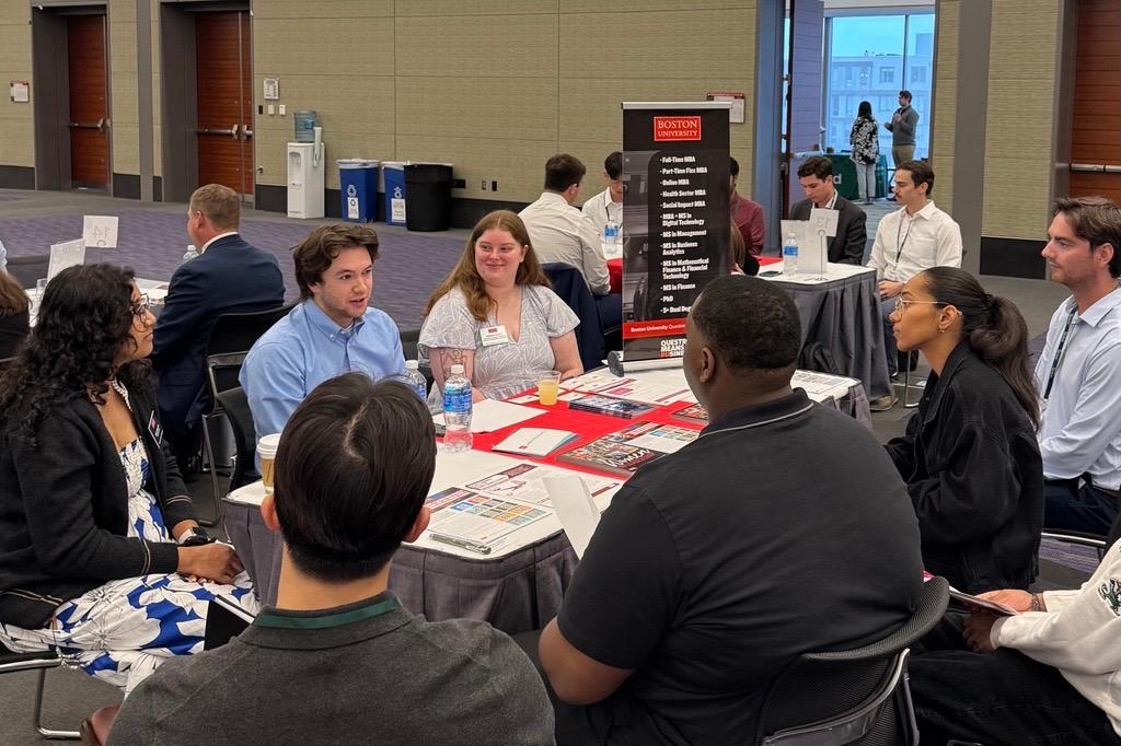 Three Boston University admissions representatives talking to five candidates during MeetUps.