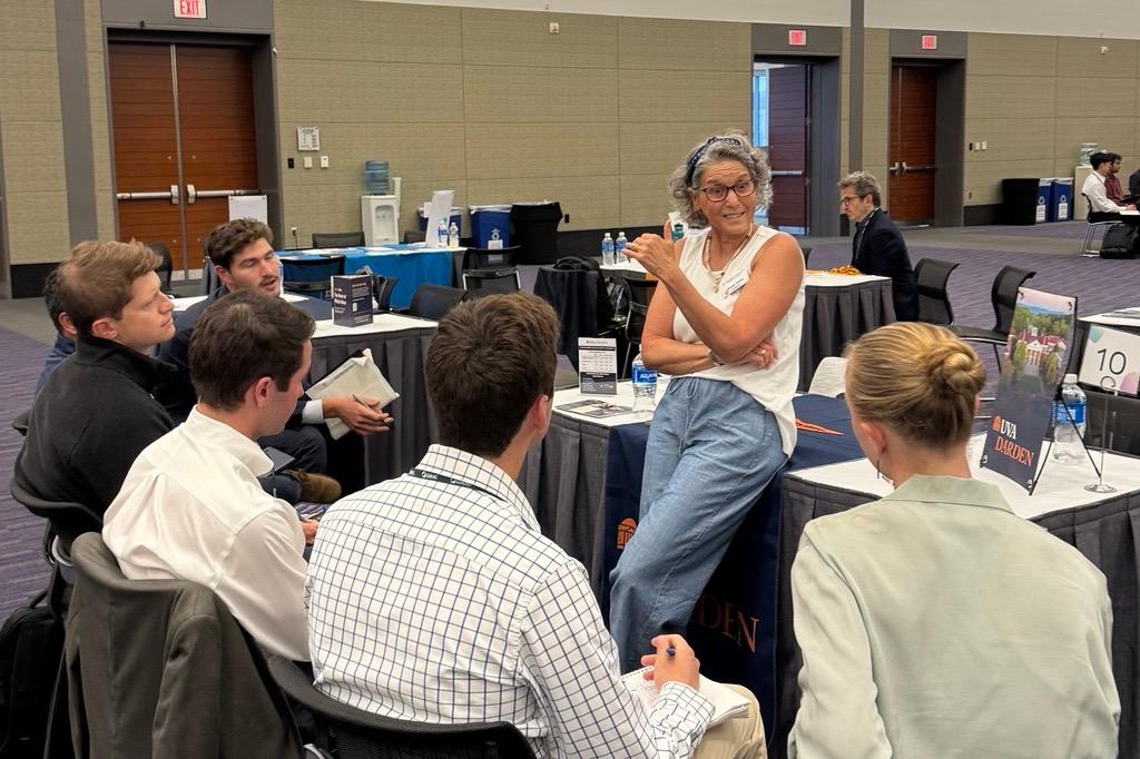 One UVA admissions representative talking to six candidates at a MeetUp table.