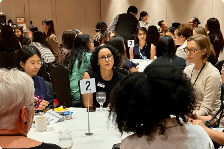 One school admissions representative talking to candidates at a pre-event breakfast