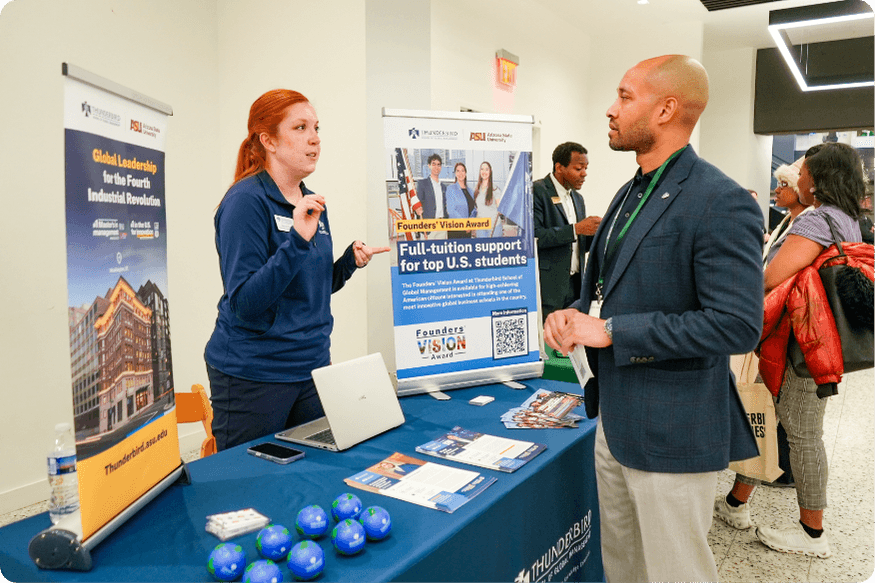One ASU Thunderbird representative talking to one candidate during the networking fair
