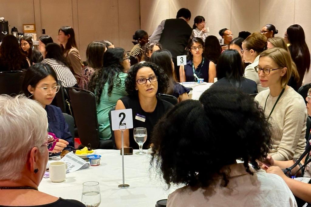 One school admissions representative talking to candidates in Canada at the women's breakfast