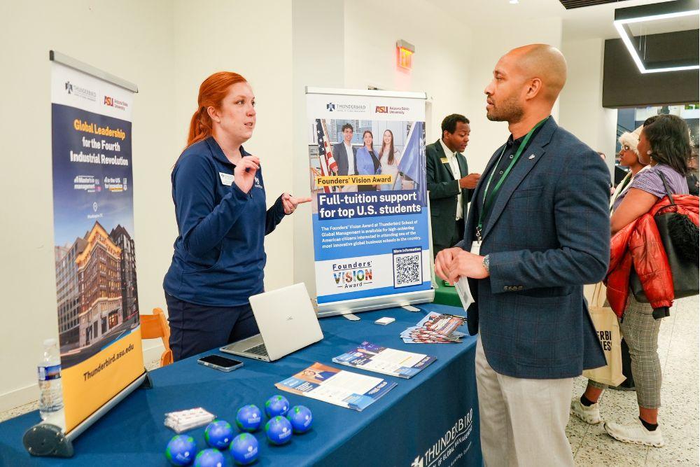 One ASU Thunderbird representative talking to one candidate during the networking fair