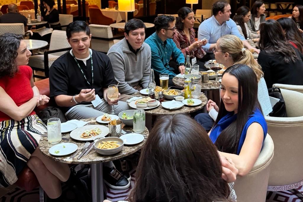 Many candidates networking while eating food.